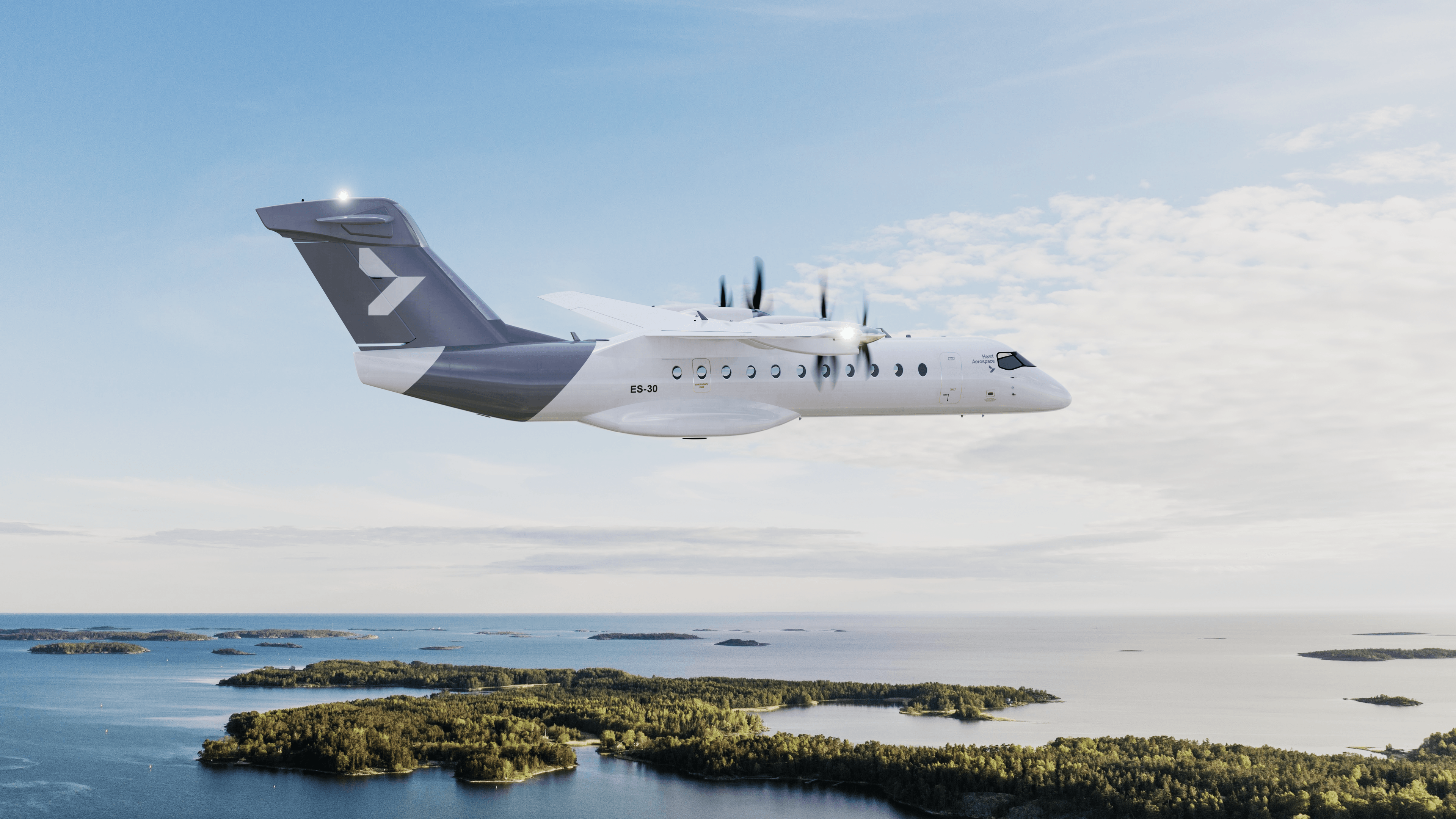 Heart Aerospace ES-30 electric aircraft banking over a coastal archipelago in bright daylight
